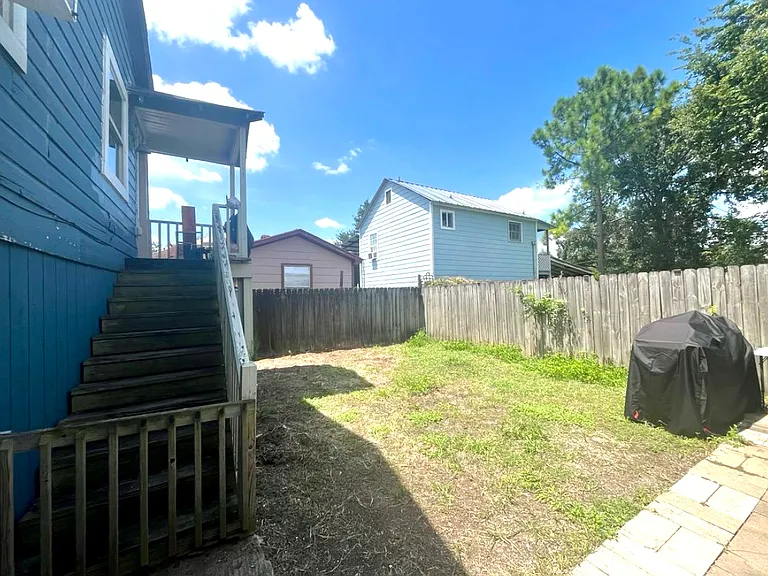 The front door is up one flight of stairs. Perfect yard, grill, and patio!