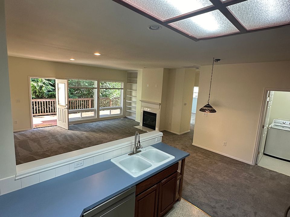 Kitchen with view into living room and deck