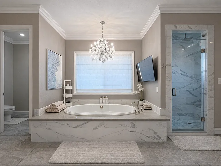 Master bath with oversized Jacuzzi tub, crystal chandelier, upgraded large steam shower and bidet