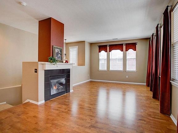 The burgundy wall color on the gas fireplace has been repainted to match the beige wall color of the rest of the interior.