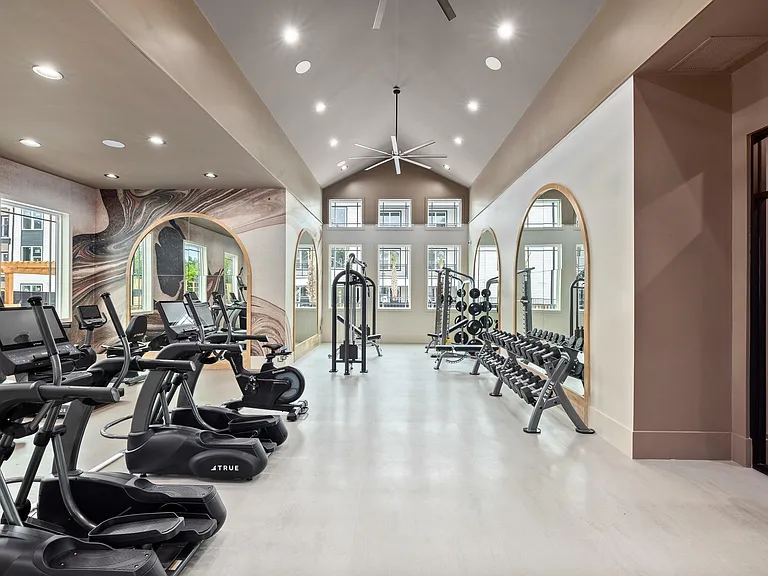 State-of-the-art apartment fitness center with cardio equipment, free weights, and dedicated stretch space.