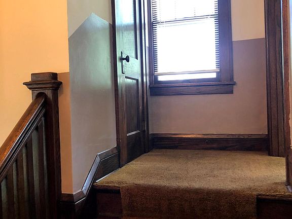 Front entry staircase with walk-in coat closet.