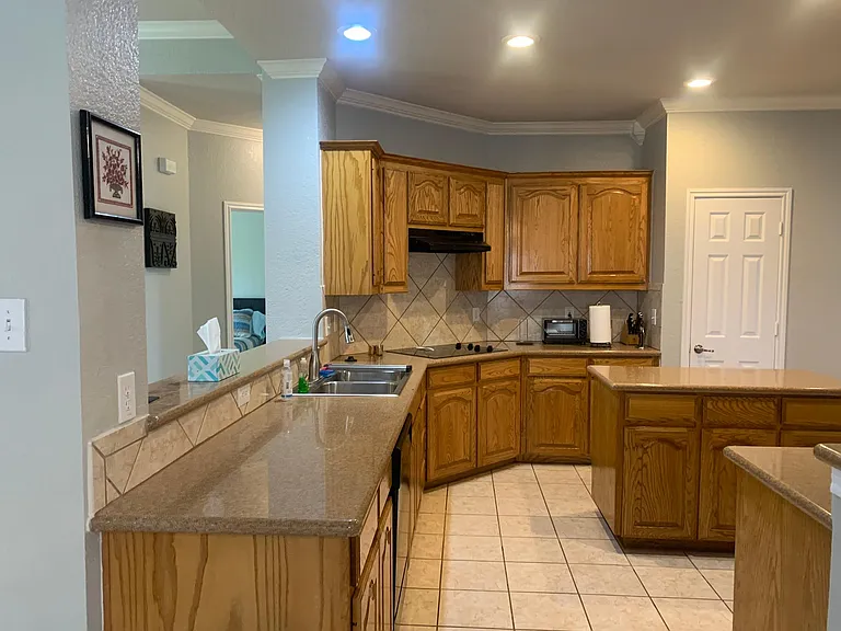 Large kitchen with island, granite countertops, large pantry and fully stocked kitchen.