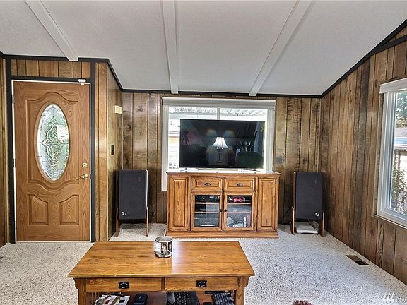 This home boasts vaulted ceilings throughout!  It also sports an updated leaded-glass front door and lots of light and bright windows that have also been updated with energy efficient white vinyl windows!