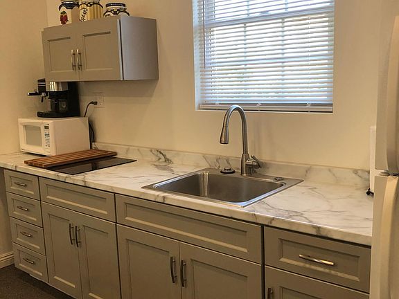 Stove, frig, garbage disposal, microwave, dishes