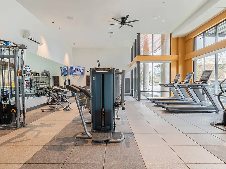 Cardio and weight stations in the club-quality fitness center