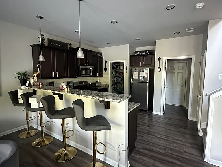 A sunlit, open-concept kitchen with bar seating_perfect for casual dining and easy entertaining