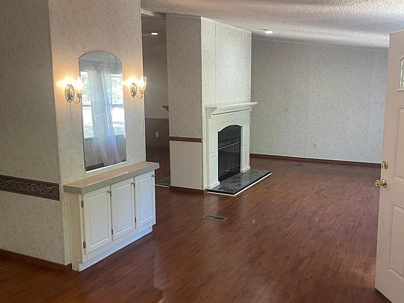 living room with two sided wood burning fireplaces