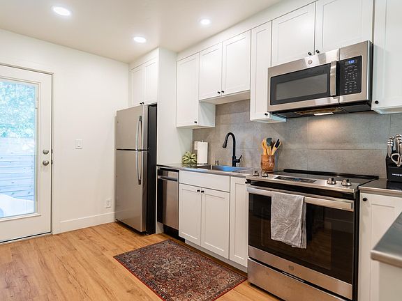 High-end slide-in oven/range, plus matching stainless microwave and refrigerator