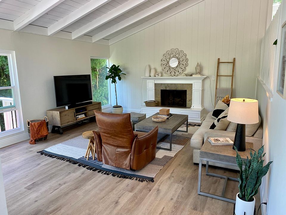 Living room that is filled with sunlight, updated windows and French Doors and access to the upper deck.
