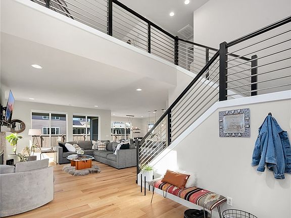 Voluminous light-filled entry with gorgeous wide plank hardwoods in the entry and throughout the family room, dining room, and kitchen.