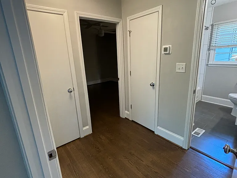 Hallway with coat closet and linen closet