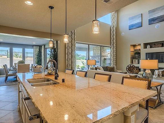 Open living space showing kitchen, dining and gathering room.