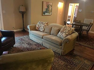 Living Room is located between kitchen and den