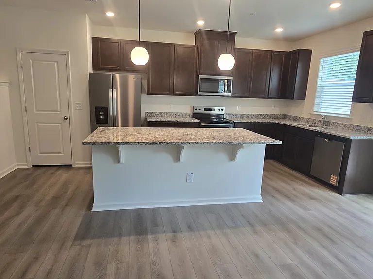 Closer look of kitchen island with pendants over the kitchen island