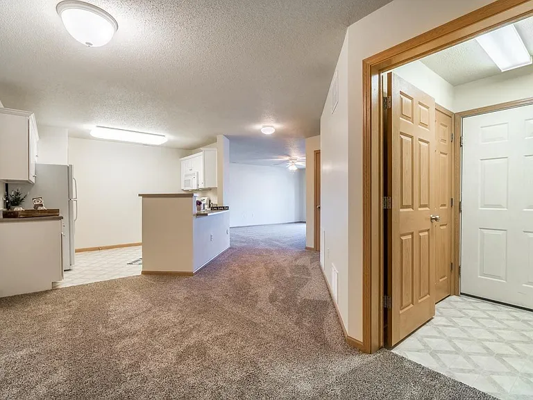 In The Cove, a welcoming entryway flows seamlessly into the open living area, perfect for greeting guests.