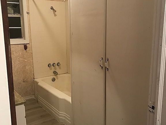 tub and shower and cabinets