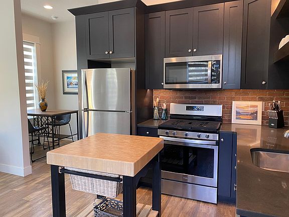 Designer kitchen with high end cabinetry, quartz, butcher block island (can be removed)