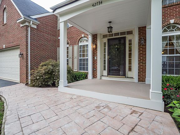 Inviting front porch with a patio walkway and composite wood