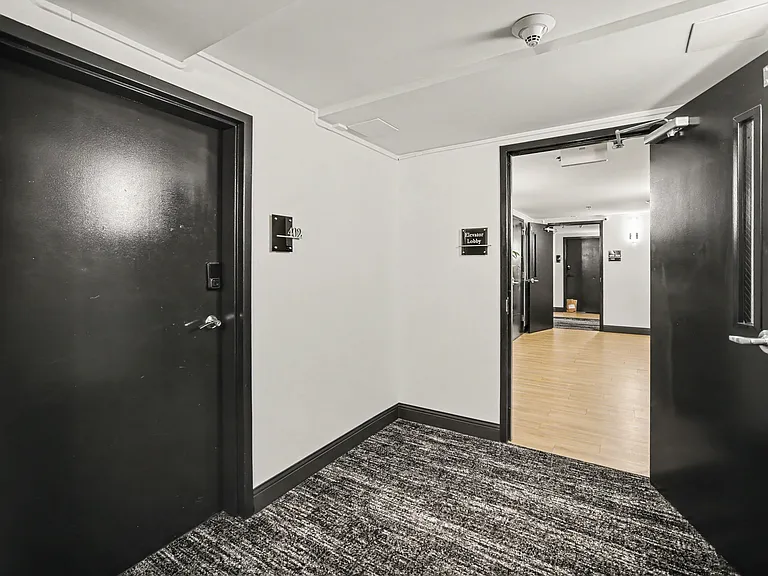 Unit is in a hallway with only one unit next to it. Next to the elevator and stairs.