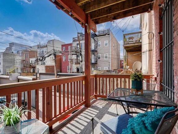Private access to sunlit balcony from back bedroom.