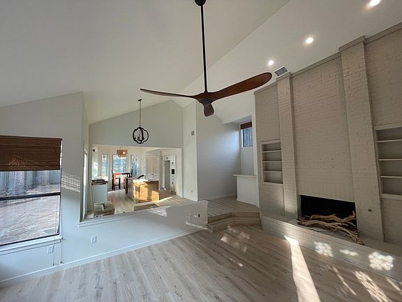 Front door view overlooking living room, dining room and open kitchen