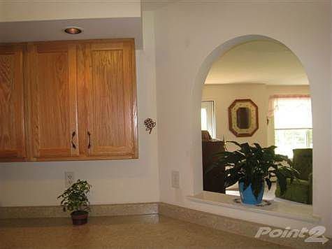 Kitchen with arched opening toward living room