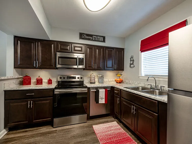 Renovated kitchen with dark cabinetry and stainless steel appliances.