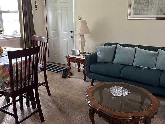 he overall design balances comfort and style, with open sightlines, coordinated decor, and room for movement, giving the entire space a welcoming and airy feel.