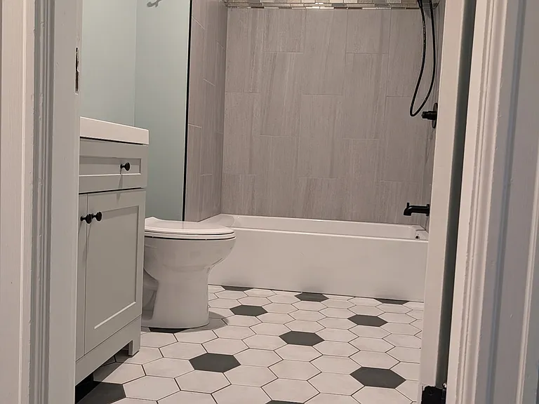 Full bathroom, new tile floors and tub surround.
