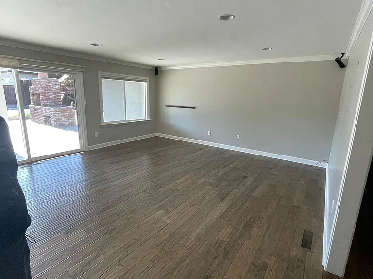 Large living and entertainment room with plenty of light opens up onto the covered porch.