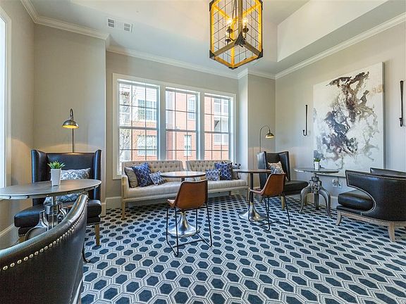 Newly Designed Resident Clubroom with TVs, Kitchen, and Lounge Seating