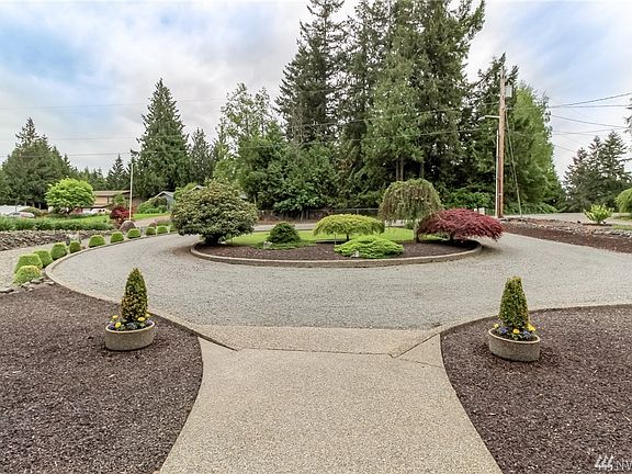 Beautiful circular driveway for arrival of your guests. Clean and pristine this landscape is easy to maintain with concrete edging and sprinkler system.