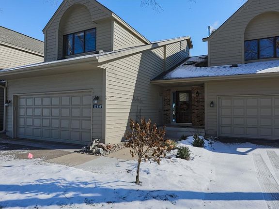 Private sidewalk and entrance with an attached 2 car garage.  There are additional parking spaces in front of townhome.