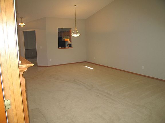 Reverse angle of the living room shows the dining area adjacent to the kitchen