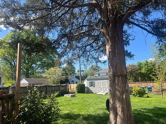 Rear fenced in yard and large storage shed