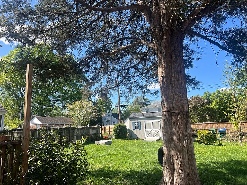 Rear fenced in yard and large storage shed
