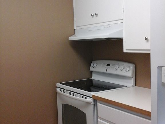 Stove and side view of refrigerator