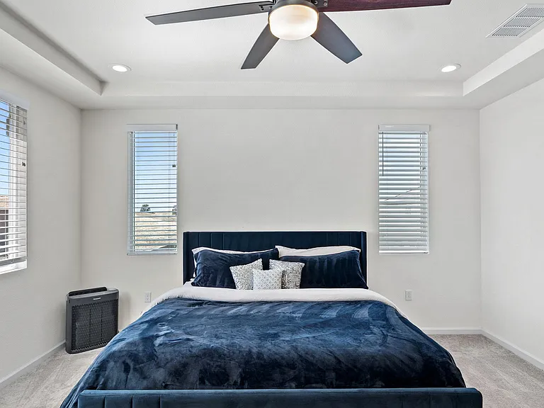Upstairs, the oversized primary suite features hillside views and abundant natural light.