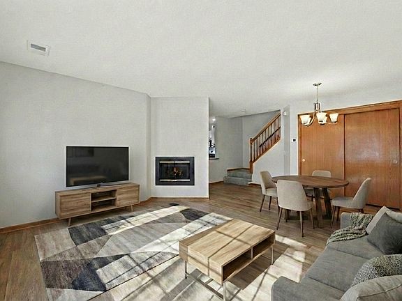 Open living room and dining room with gas fireplace. Brand new flooring throughout the home.