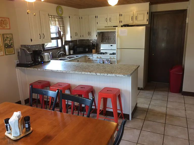 Kitchen, breakfast bar, dining table; door to washer and dryer