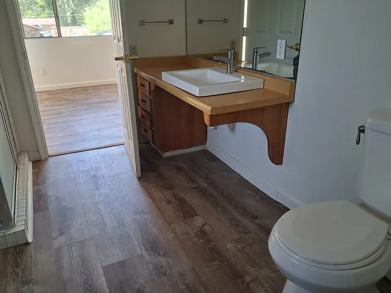 Bath with stall shower joins the two bedrooms