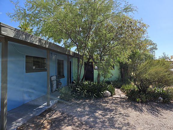 Beautiful Lysiloma trees and various groundcover plants adorn the front of this duplex with brand new exterior paint.