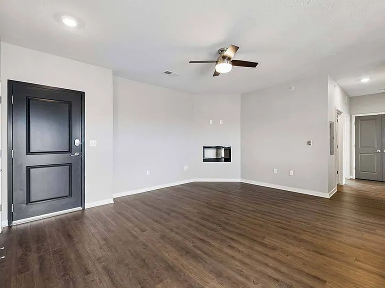 A cozy fireplace and expansive layout create a welcoming living space that's perfectly suited for relaxing evenings and effortless entertaining.