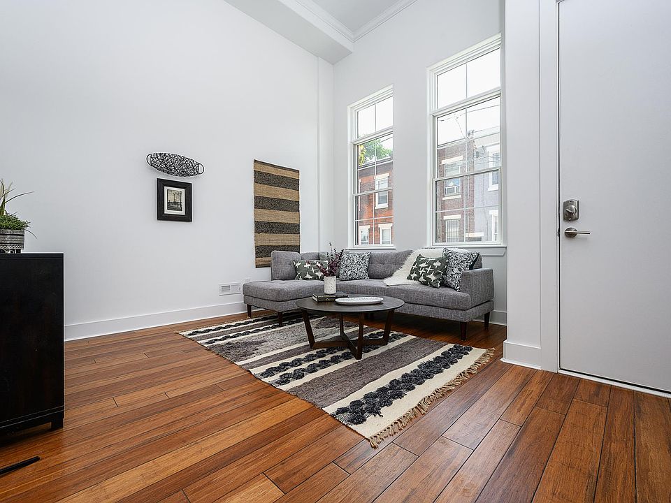 Living room with extra high ceilings, open to kitchen and dining