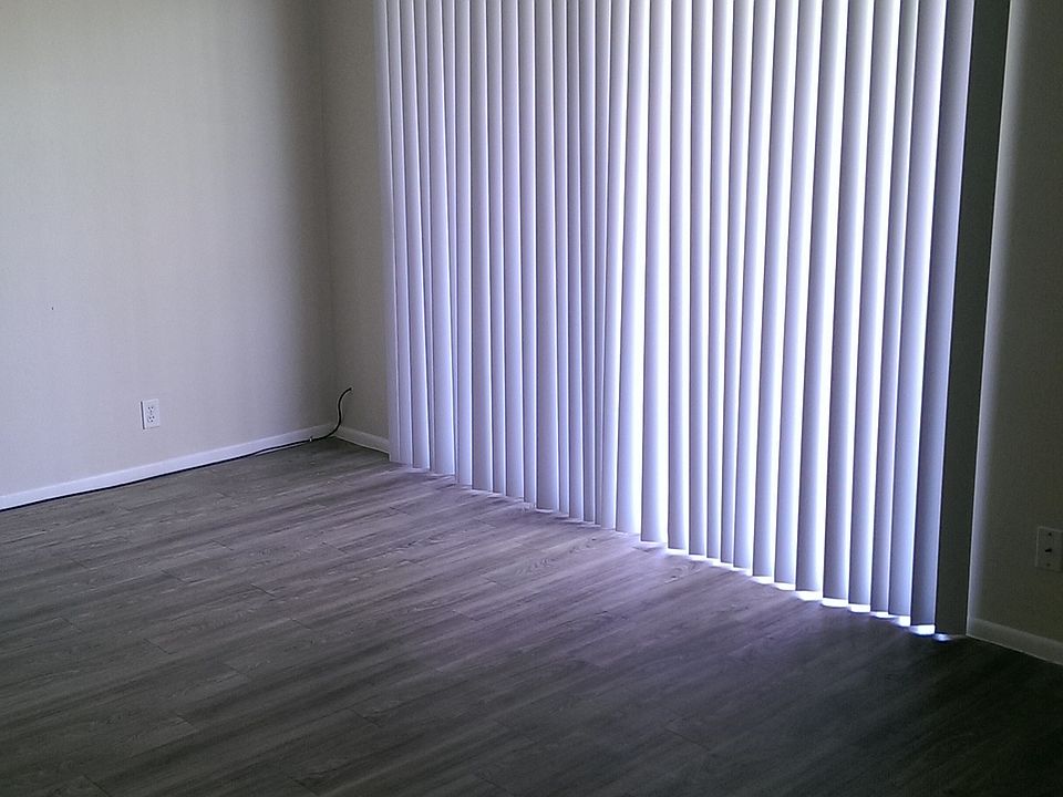 Spacious living room with hardwood inspired flooring