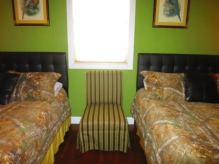 The second bedroom is furnished with two queen size beds