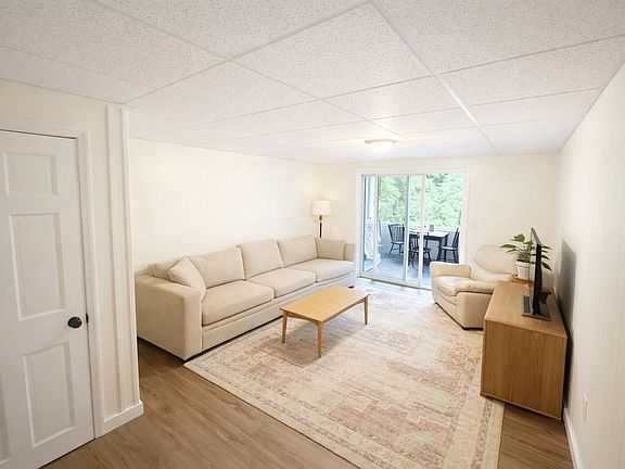Living room with slider access to screened porch