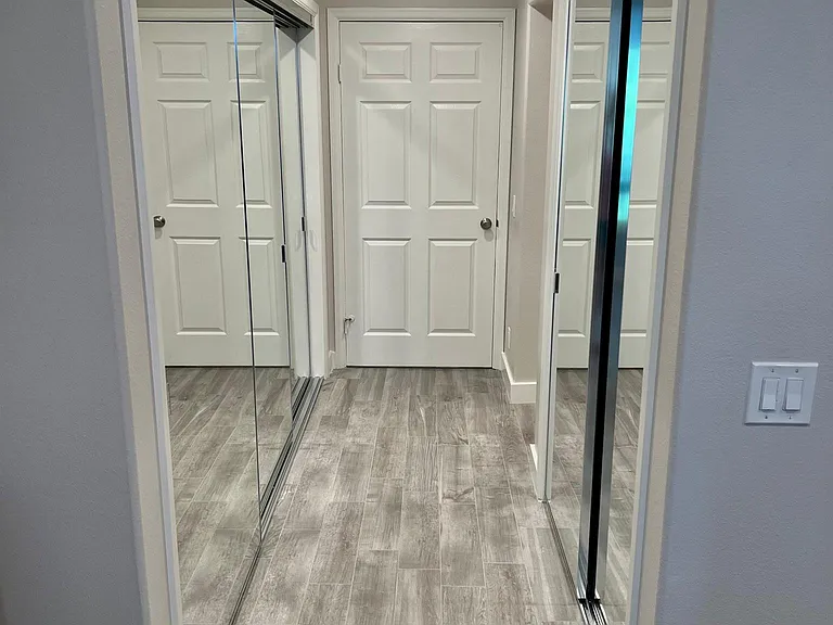Primary bedroom hallway with large closets on both sides