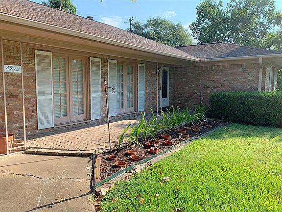 Floor-to-ceiling windows across the front of home. Inviting brick paver front porch entry. Storm door.